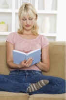 girl sitting in yoga position reading book